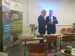 Kerhon puheenjohtaja Erkki Naumanen (oik.) palkitseen esitelmöitsijä eversti evp. Hannes Bjurnströmin Saksanniemi kirjalla.